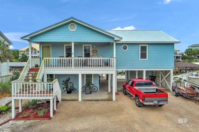 view of front of house with a porch and a carport