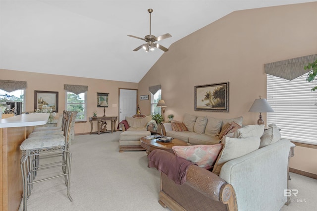 carpeted living room with high vaulted ceiling and ceiling fan