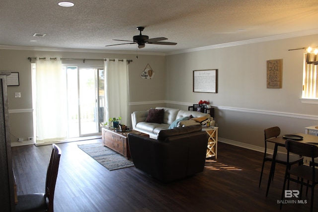 living room featuring visible vents, crown molding, wood finished floors, a textured ceiling, and a ceiling fan