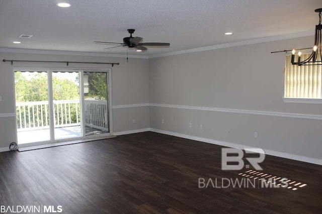 empty room featuring crown molding, wood finished floors, and baseboards