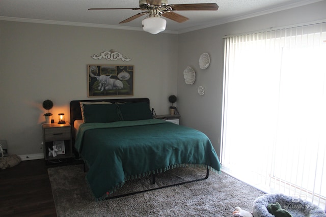 bedroom with wood finished floors, ceiling fan, and ornamental molding