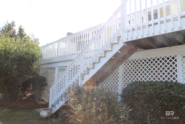 exterior space featuring a wooden deck and stairs