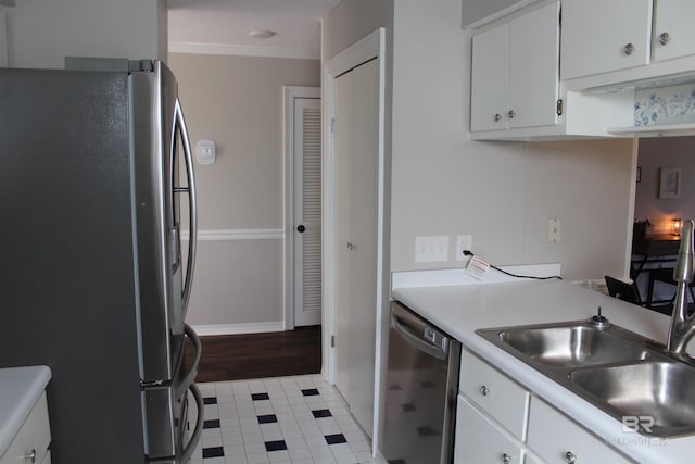 kitchen with white cabinets, appliances with stainless steel finishes, a textured ceiling, and light countertops