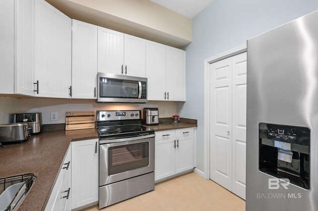 kitchen featuring white cabinetry, light tile patterned floors, and appliances with stainless steel finishes