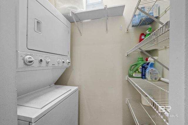 laundry room with stacked washer / drying machine