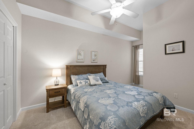 bedroom featuring light carpet, a closet, and ceiling fan