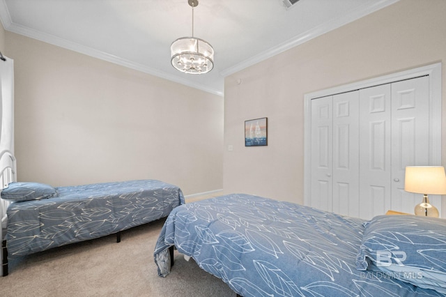 carpeted bedroom with a chandelier, a closet, and ornamental molding