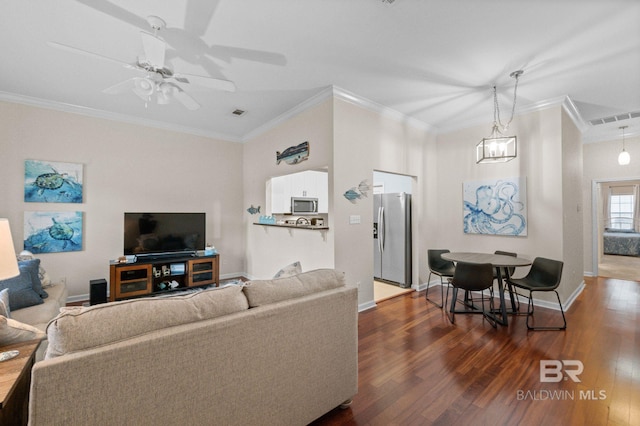 living room with dark hardwood / wood-style floors, ceiling fan, and ornamental molding