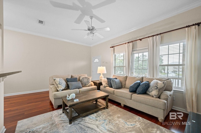 living room featuring plenty of natural light, dark hardwood / wood-style floors, and crown molding