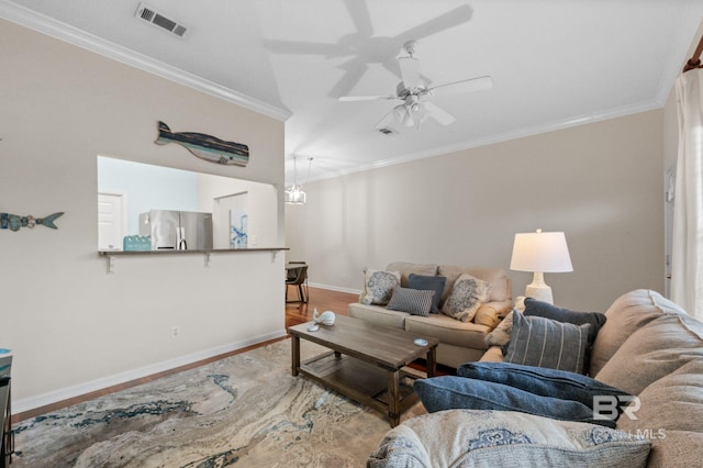 living room with crown molding, hardwood / wood-style floors, and ceiling fan