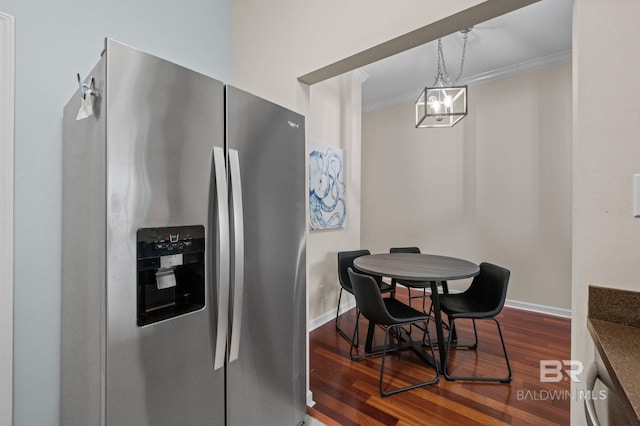 kitchen with stainless steel fridge, a chandelier, dark hardwood / wood-style floors, and ornamental molding