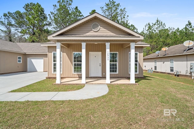 view of front of house with a garage, covered porch, and a front lawn