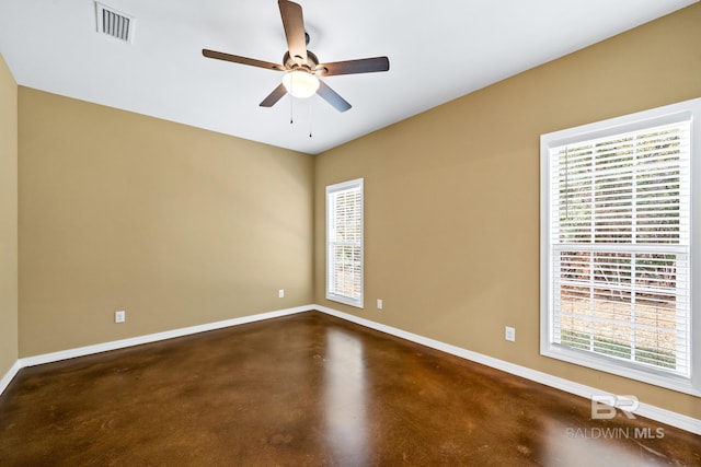 spare room featuring concrete floors and ceiling fan