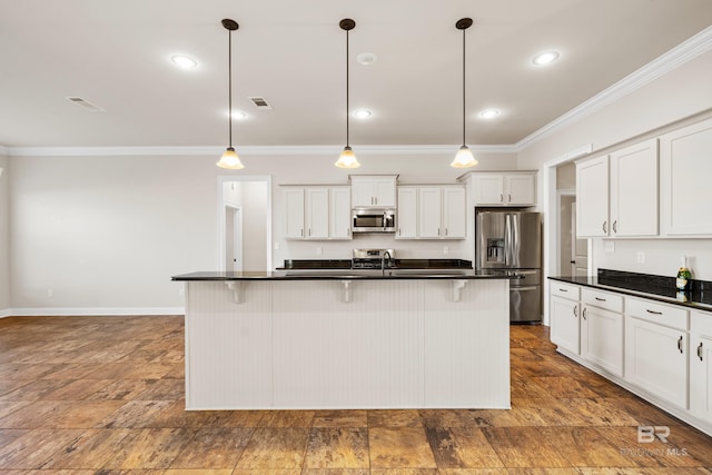 kitchen with white cabinets, decorative light fixtures, and appliances with stainless steel finishes