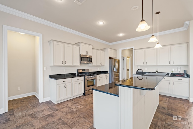 kitchen with white cabinetry, stainless steel appliances, pendant lighting, a center island with sink, and ornamental molding