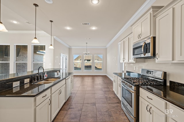 kitchen featuring white cabinetry, sink, hanging light fixtures, appliances with stainless steel finishes, and ornamental molding