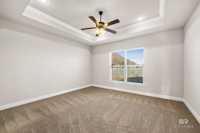 unfurnished room featuring carpet flooring, a tray ceiling, ceiling fan, and ornamental molding