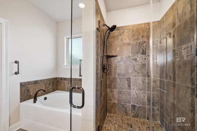 bathroom featuring shower with separate bathtub