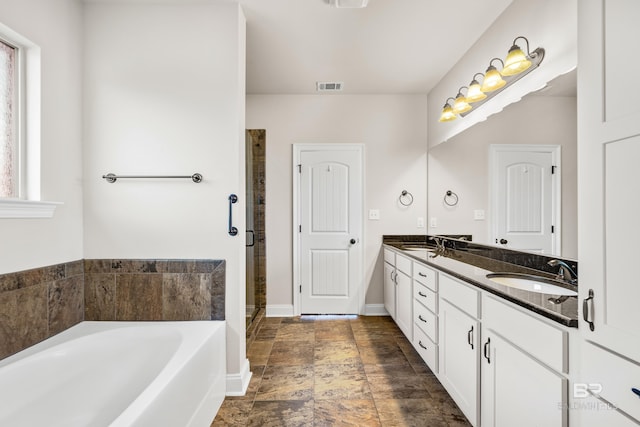 bathroom featuring shower with separate bathtub and vanity