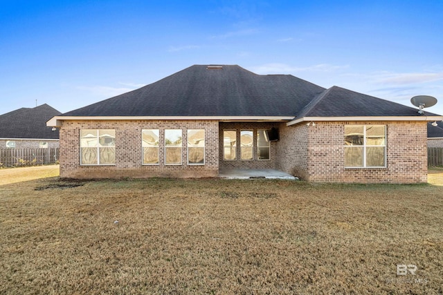 back of house with a patio area and a lawn