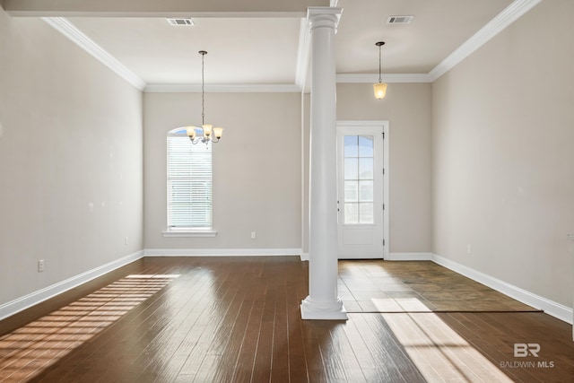 unfurnished dining area featuring wood-type flooring, an inviting chandelier, ornate columns, and ornamental molding