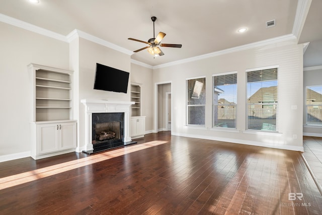 unfurnished living room with dark hardwood / wood-style flooring, ceiling fan, crown molding, built in features, and a premium fireplace