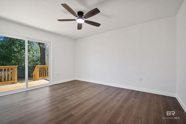 unfurnished room with dark wood-type flooring, baseboards, and a ceiling fan