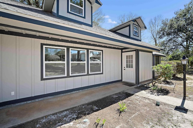 exterior space featuring a shingled roof