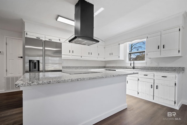 kitchen featuring black electric stovetop, island range hood, a sink, visible vents, and stainless steel fridge