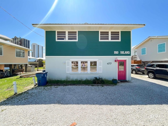 477 E 2nd Ave, Gulf Shores, AL 36542 - view of front facade with driveway and stucco siding
