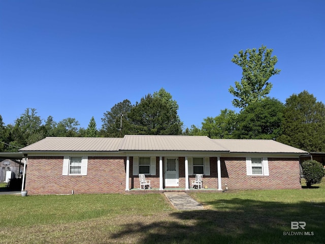 single story home featuring a porch, a front lawn, metal roof, and brick siding