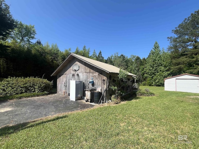 detached garage featuring a storage shed