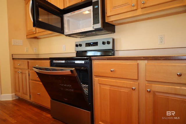 kitchen featuring baseboards, dark wood-style floors, and stainless steel range with electric cooktop