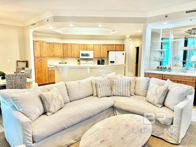 living area featuring recessed lighting, visible vents, and crown molding