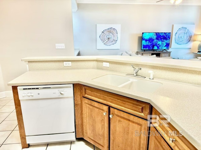 kitchen featuring light tile patterned floors, light countertops, brown cabinetry, a sink, and dishwasher