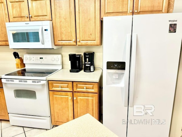 kitchen with white appliances, light countertops, and light tile patterned flooring