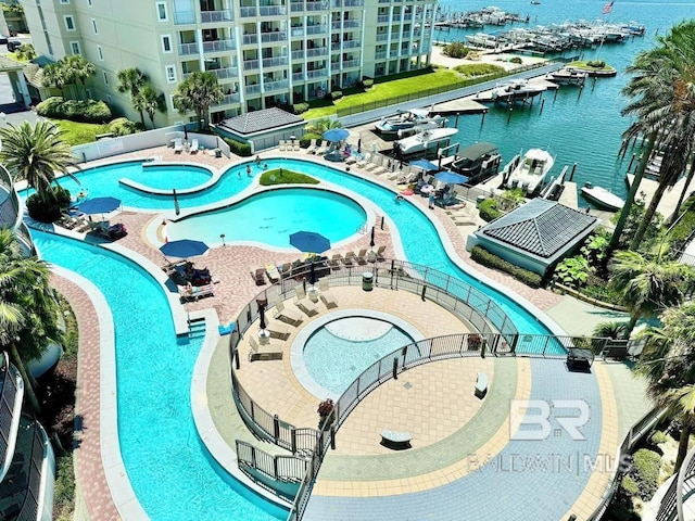 community pool featuring a water view and a patio