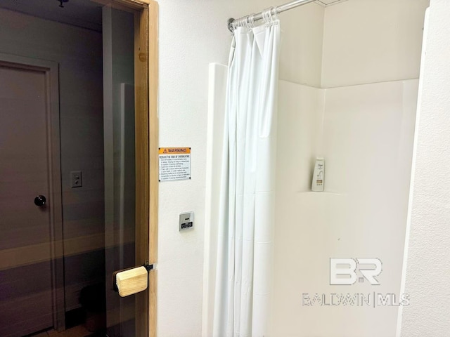 bathroom with a shower with curtain