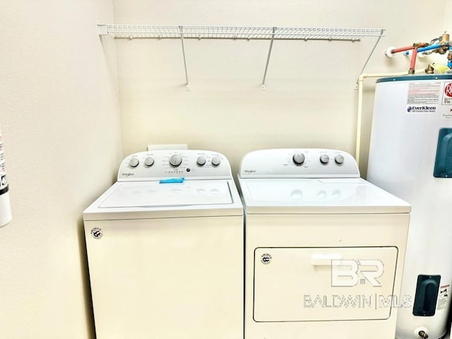 laundry room with washer and dryer, laundry area, and electric water heater