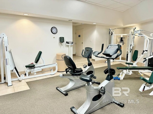 gym with a drop ceiling and tile patterned floors