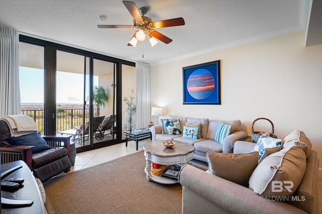 tiled living room featuring a textured ceiling, french doors, ornamental molding, expansive windows, and ceiling fan