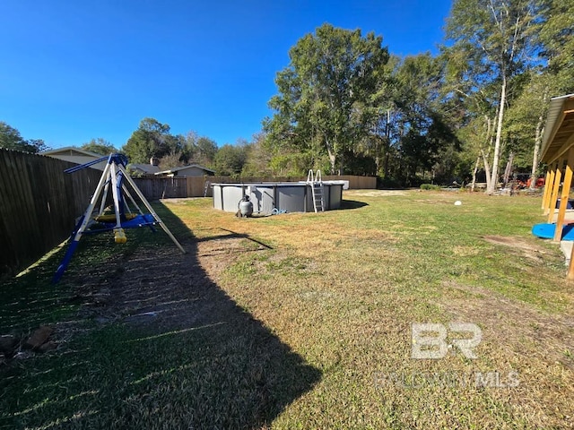 view of yard with a fenced in pool