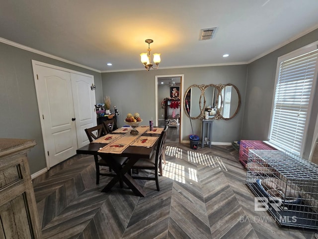 dining room featuring crown molding, a notable chandelier, and parquet flooring