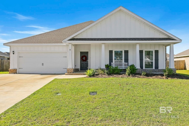 view of front of property with a front lawn, covered porch, and a garage