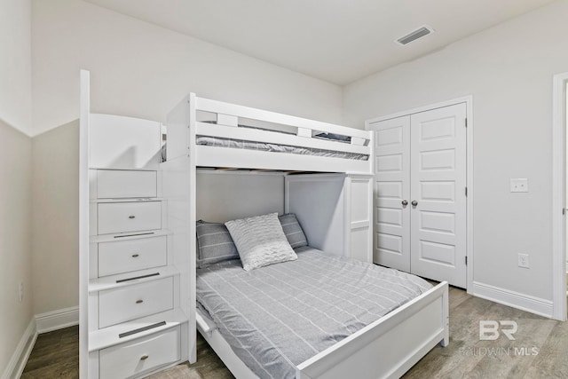 bedroom with a closet and wood-type flooring