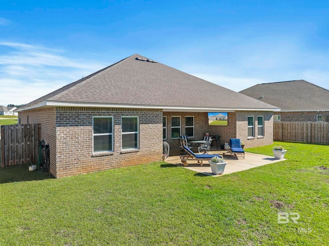 back of property featuring a yard and a patio