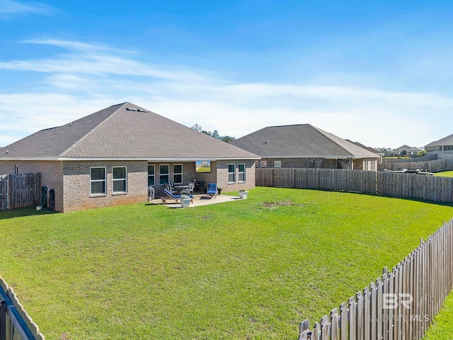 rear view of property with a patio and a lawn