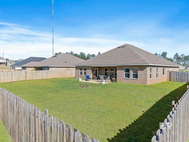 back of house with a patio and a lawn