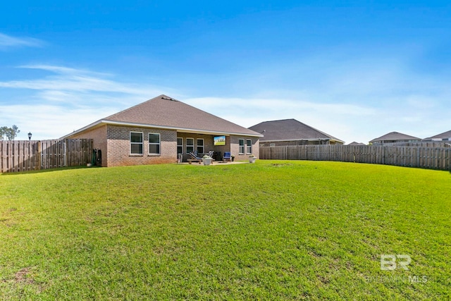 back of property featuring a yard and a patio