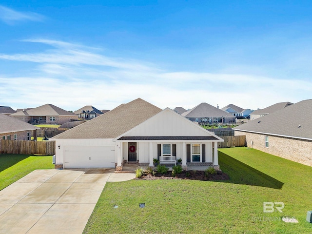 view of front of house featuring a porch, a garage, and a front lawn